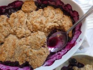 top down view of healthier blueberry cobbler with spoon