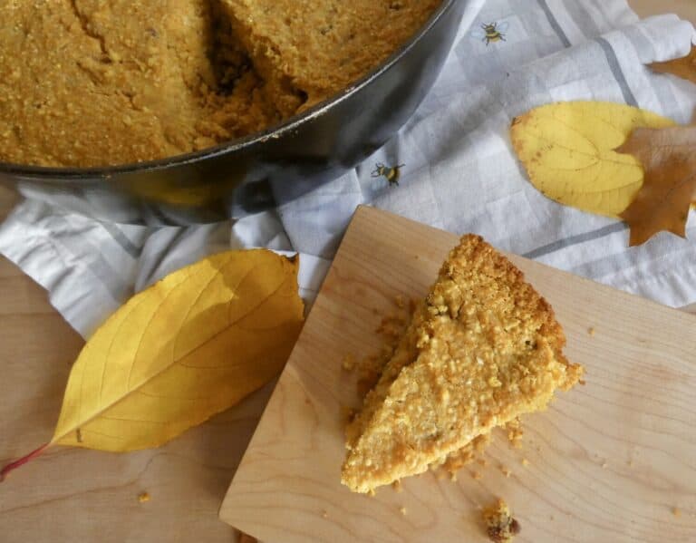 overhead of slice of pumpkin pecan skillet cornbread