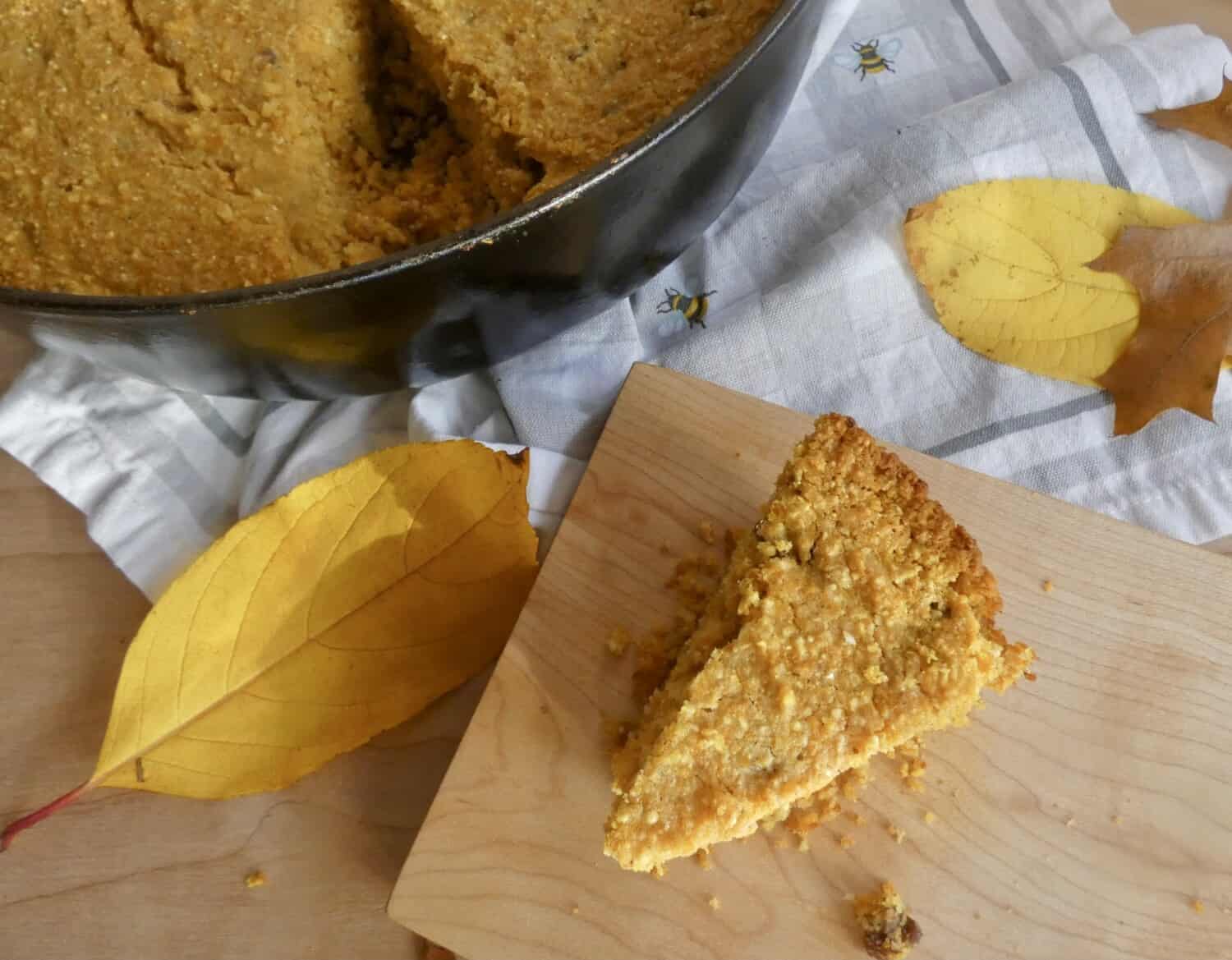 overhead of slice of pumpkin pecan skillet cornbread