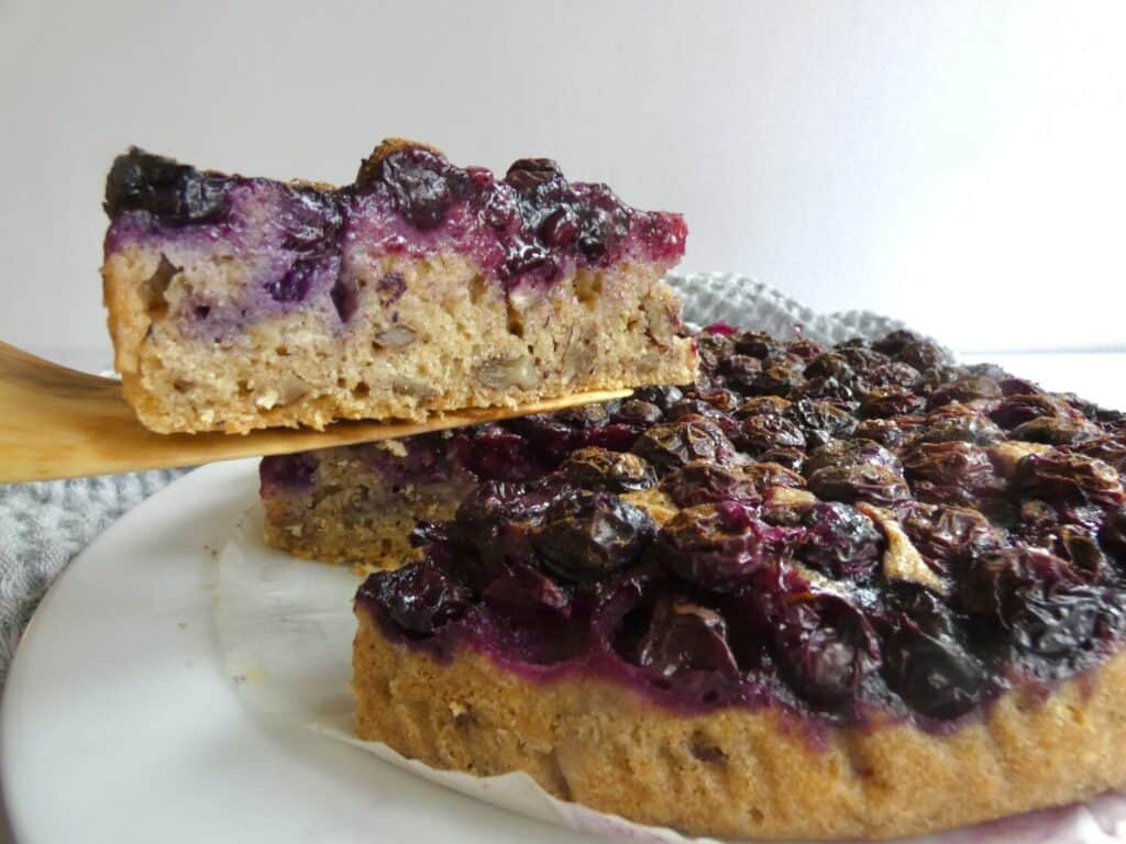 slice of Healthy One-Bowl Berry Cake lifted up