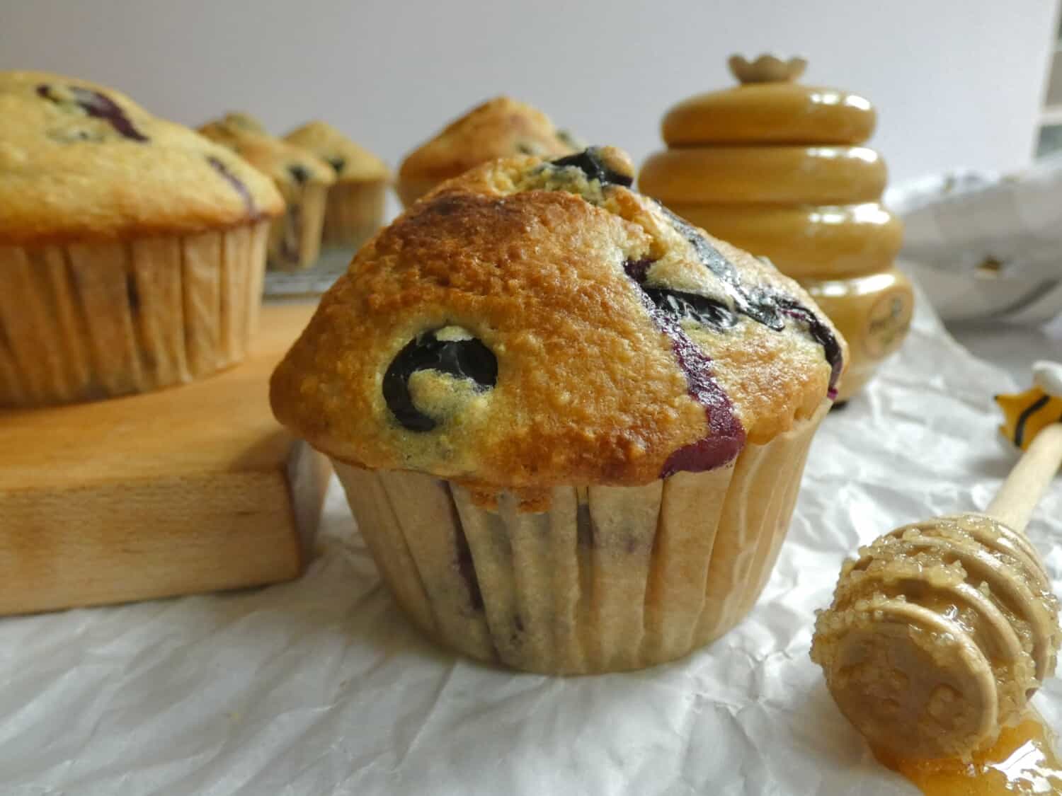 blueberry cornbread muffin with honey dipper