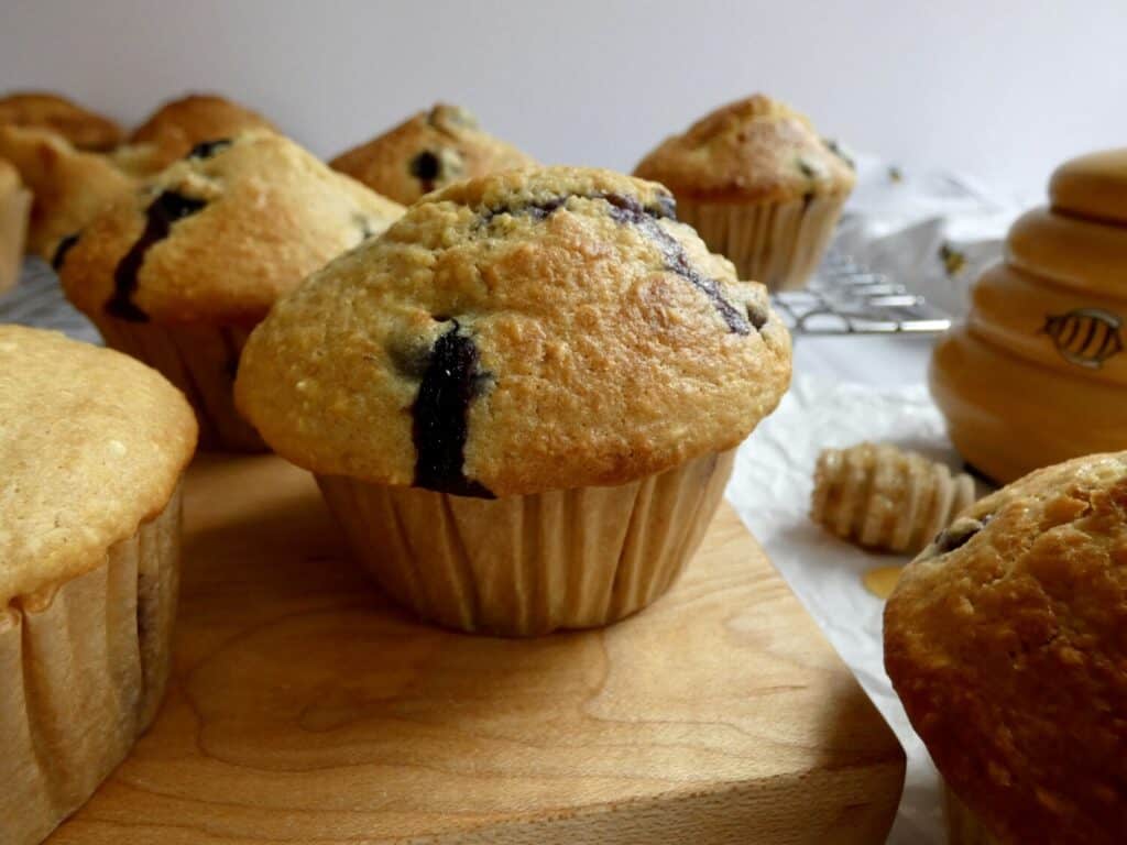 blueberry cornbread muffin in front of wire cooling rack