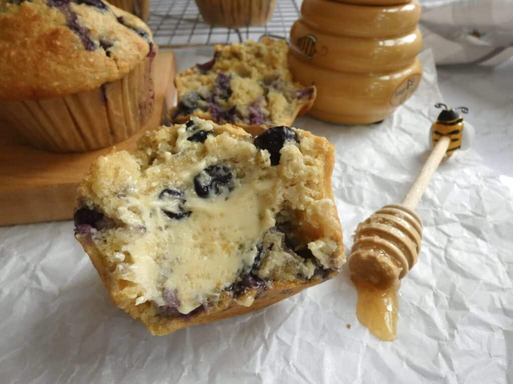 blueberry cornbread muffin with smear of butter and honey