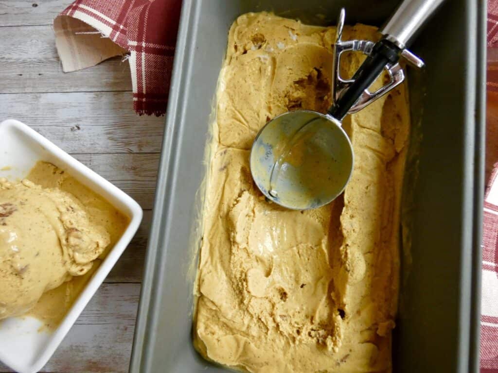 top down view of maple pumpkin ice cream with pecans in a container