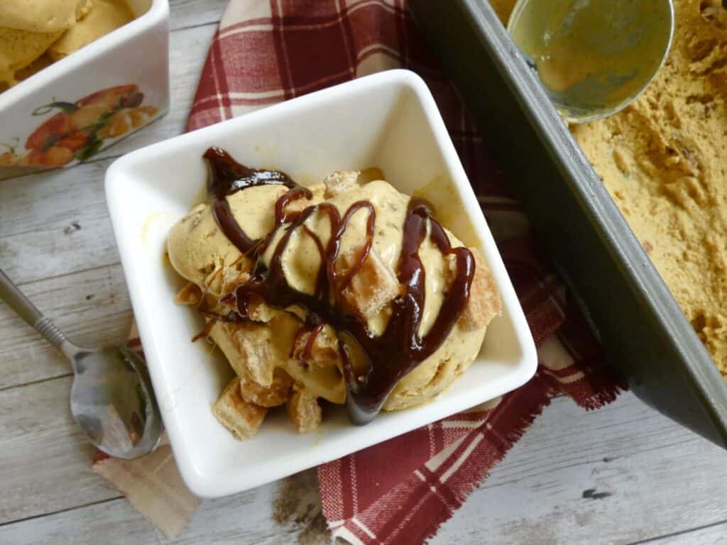 Top down view of maple pumpkin pecan ice cream with pecans and apple caramel