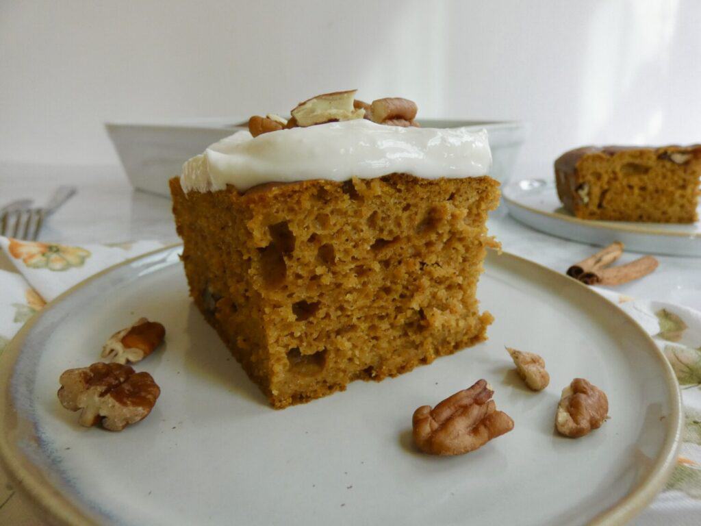 simple sourdough discard pumpkin cake with cream cheese frosting on a plate