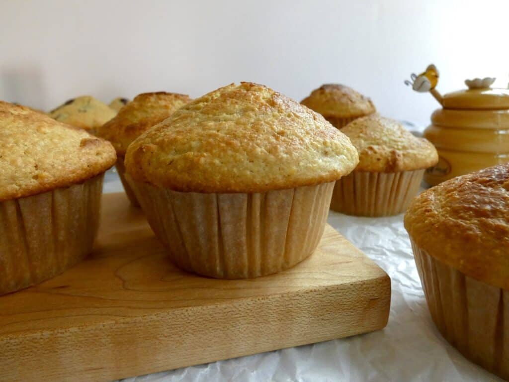 bakery style cornbread muffins on wooden board