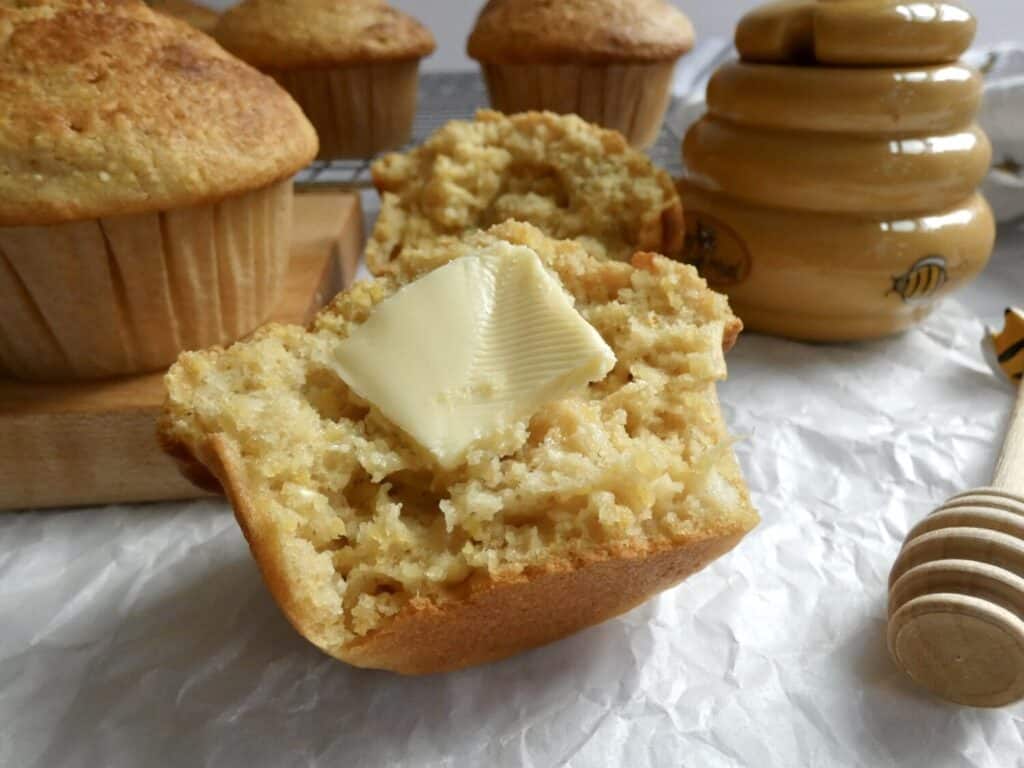 bakery style cornbread muffin with slice of butter