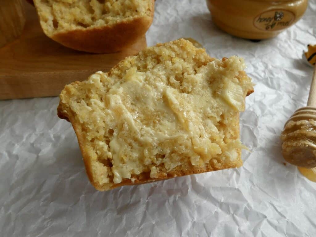 bakery style cornbread muffin with honey butter