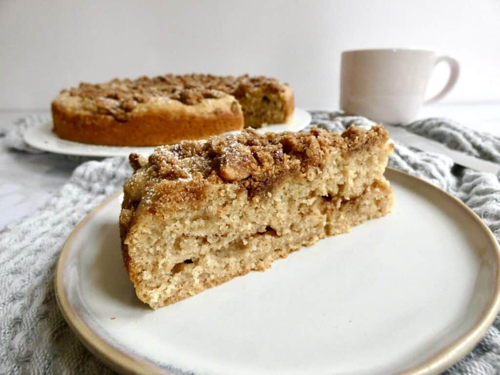 slice of apple cider coffee cake with pecan streusel on a plate