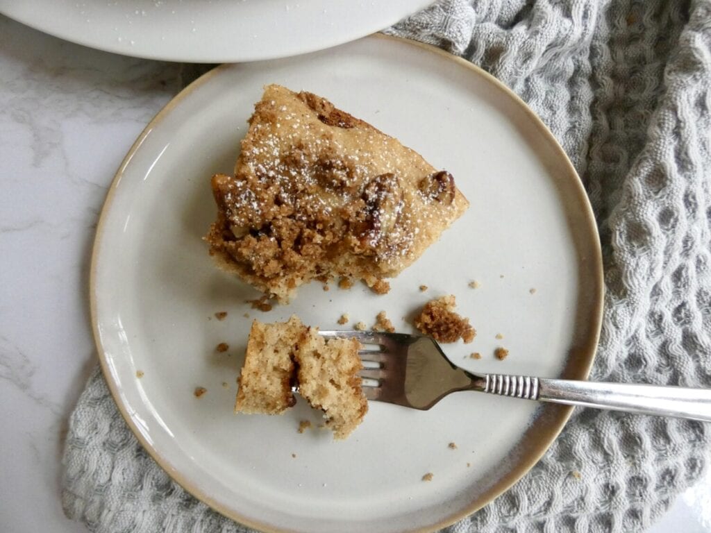 top down view of apple cider coffee cake with pecan streusel on plate