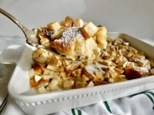 close up of apple bread pudding on serving spoon