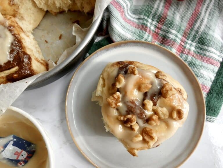 banana bread cinnamon roll with chopped walnuts and icing