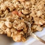 Healthy apple crumble on serving spoon