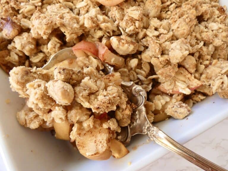 Healthy apple crumble on serving spoon
