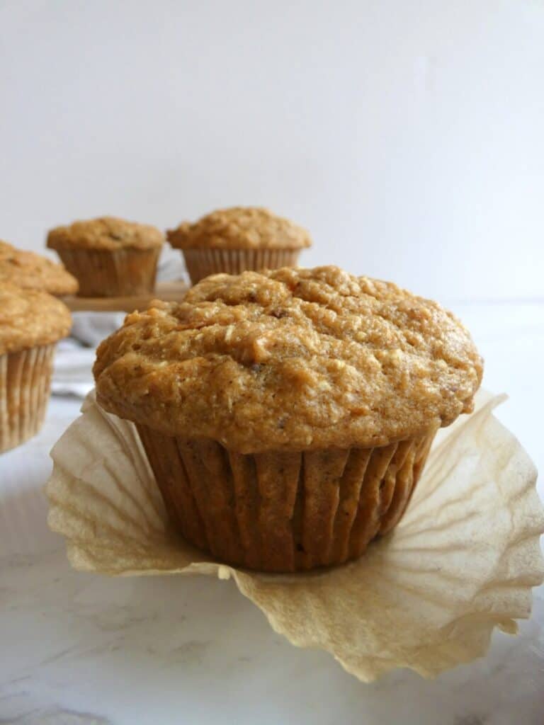 vertical close up of healthy carrot cake muffin