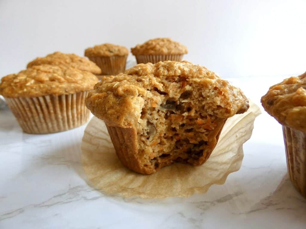 healthy carrot cake muffin with a bite missing