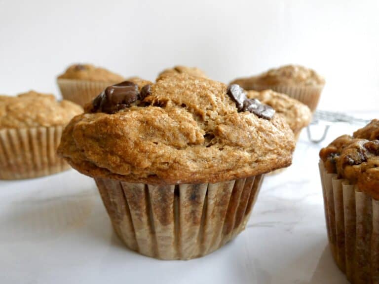 healthier chocolate chip banana muffin on marble counter