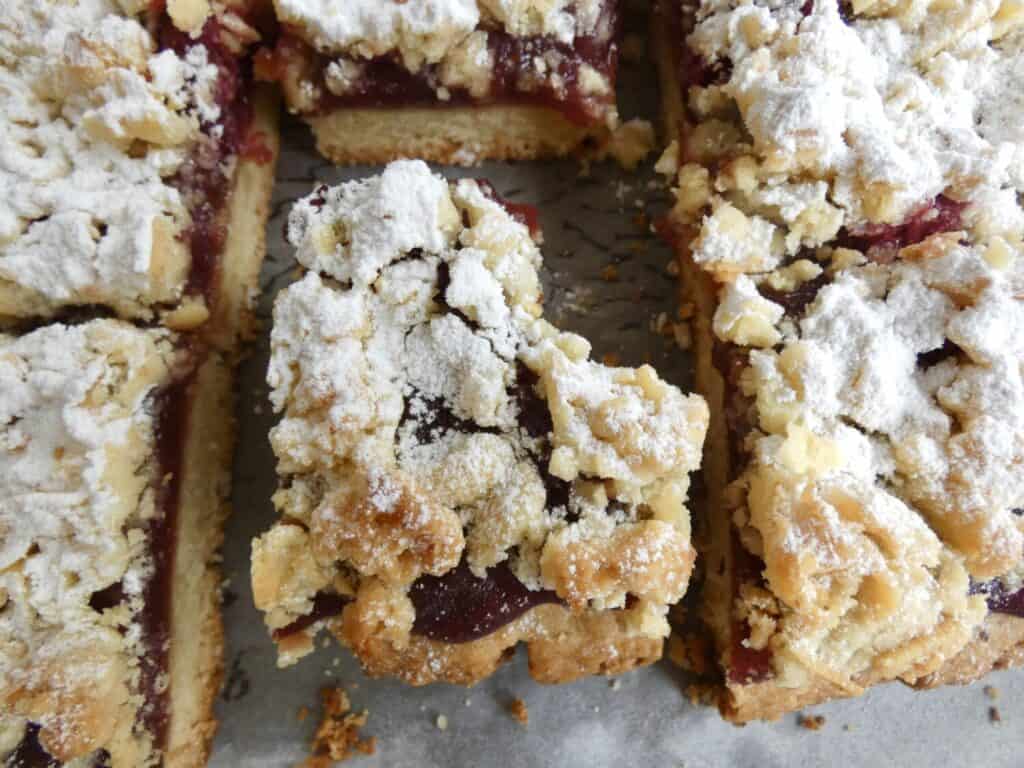 top down image of raspberry crumb bar with missing bite