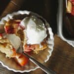 bowl of Easy Jammy Strawberry Cake with vanilla ice cream