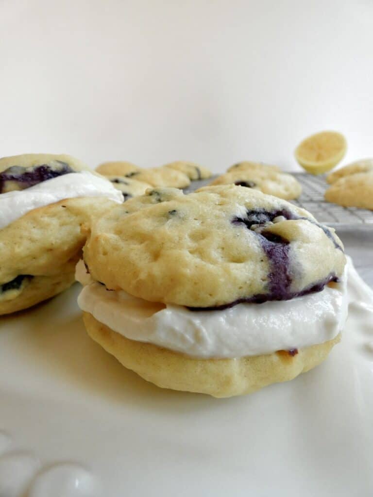 healthier blueberry whoopie pies on a plate with wire rack in background