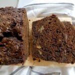 two slices of healthier double chocolate zucchini bread on a cutting board