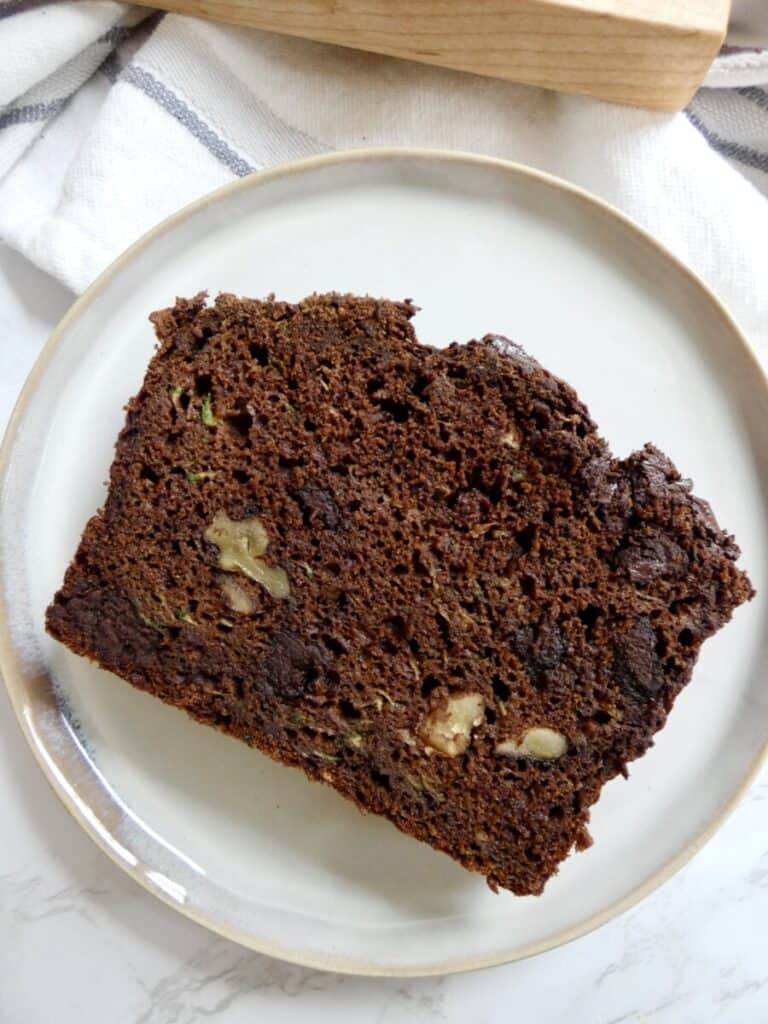 vertical top down image of a slice of healthier double chocolate zucchini bread