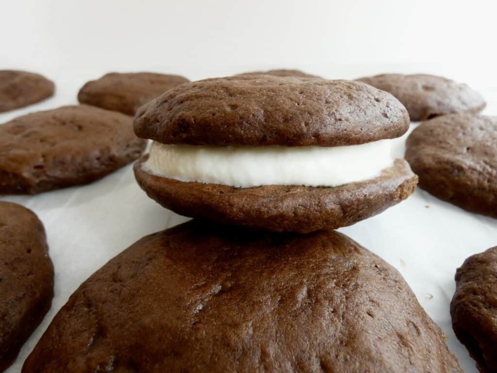 close up of a healthier chocolate whoopie pie on a piece of parchment paper