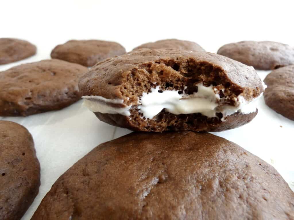 a healthier chocolate whoopie pie with a bite taken out of it