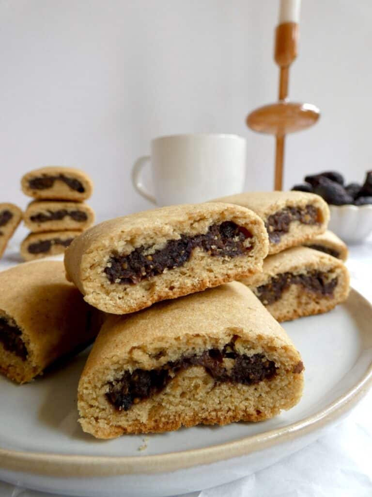 a round plate with Healthy Homemade Fig Newtons and a mug in the background