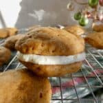 gingerbread whoopie pie with filling on wire cooling rack