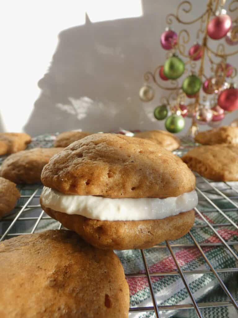 vertical image of gingerbread whoopie pie on wire cooling rack