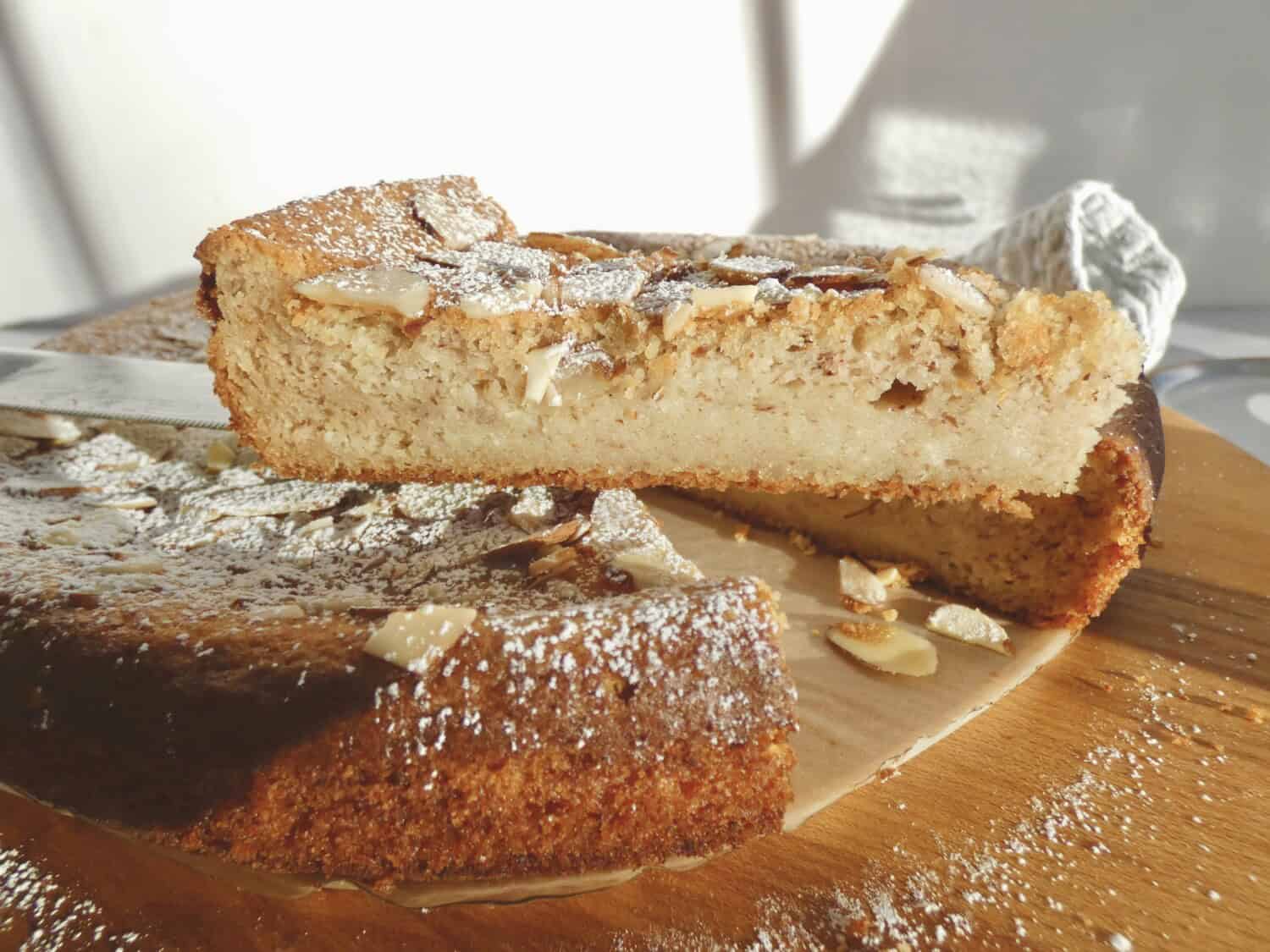 slice of almond ricotta cake on a cake server